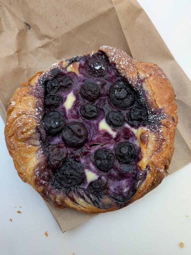 Blueberry danish with glossy fruit filling and flaky puff pastry